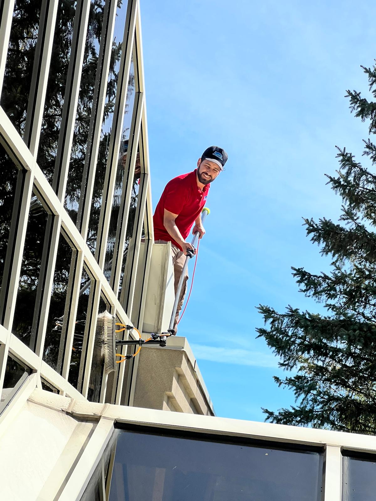 Technician cleaning high-rise windows with a water-fed pole in Vaughan, Ontario